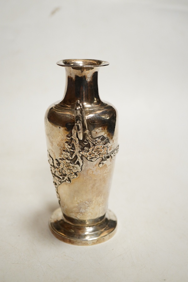 A Chinese export silver twin handed vase c.1900, stamped KC, artisans mark, decorated in relief with flowering prunus branches, height 13cm., weight approx. 4.72ozt